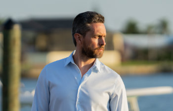 handsome mature man standing by the water